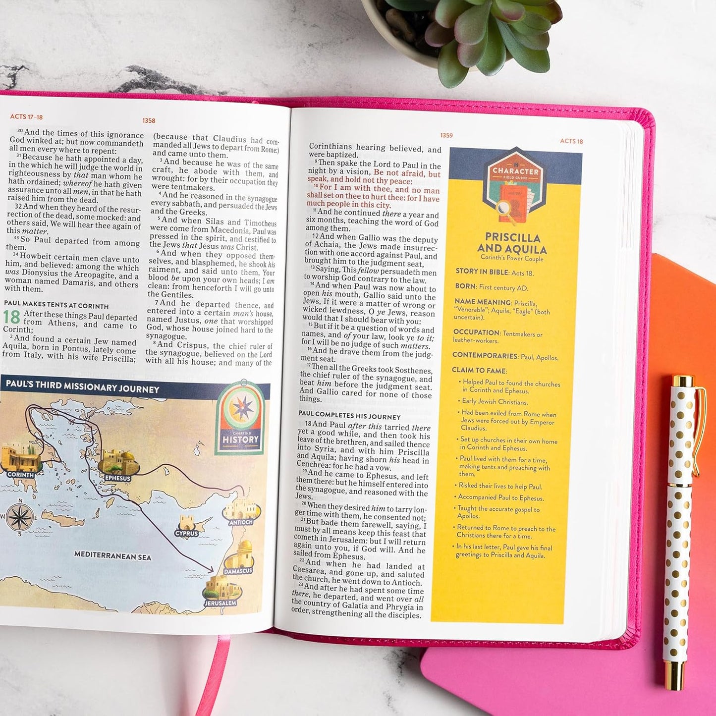 KJV Explorer Bible for Kids – Bubble Gum LeatherTouch (Full-Color Study Edition). Open Bible with educational content on a pink surface, pen, and plant in the background