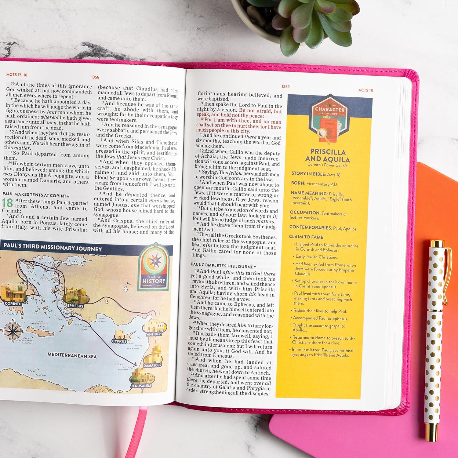 KJV Explorer Bible for Kids – Bubble Gum LeatherTouch (Full-Color Study Edition). Open Bible with educational content on a pink surface, pen, and plant in the background